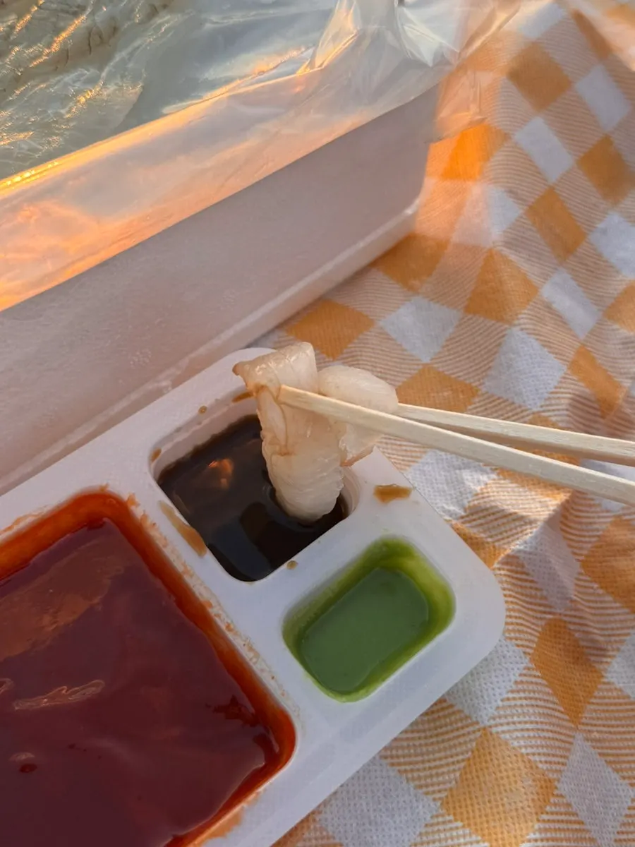 Sashimi spread on the beach as the sun sets