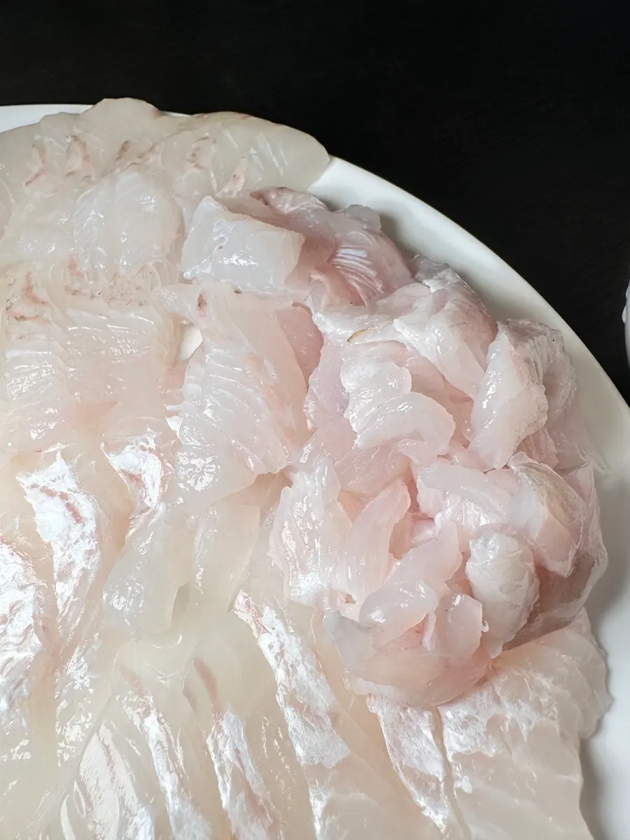 Flounder sashimi spread wide on a plate