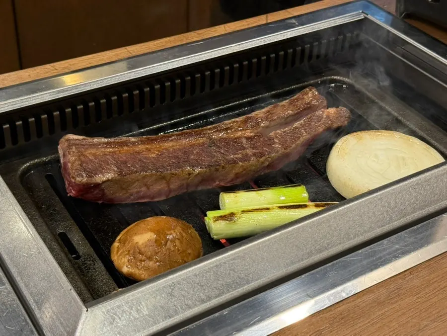 Grilling rib-eye galbi over the charcoal brazier