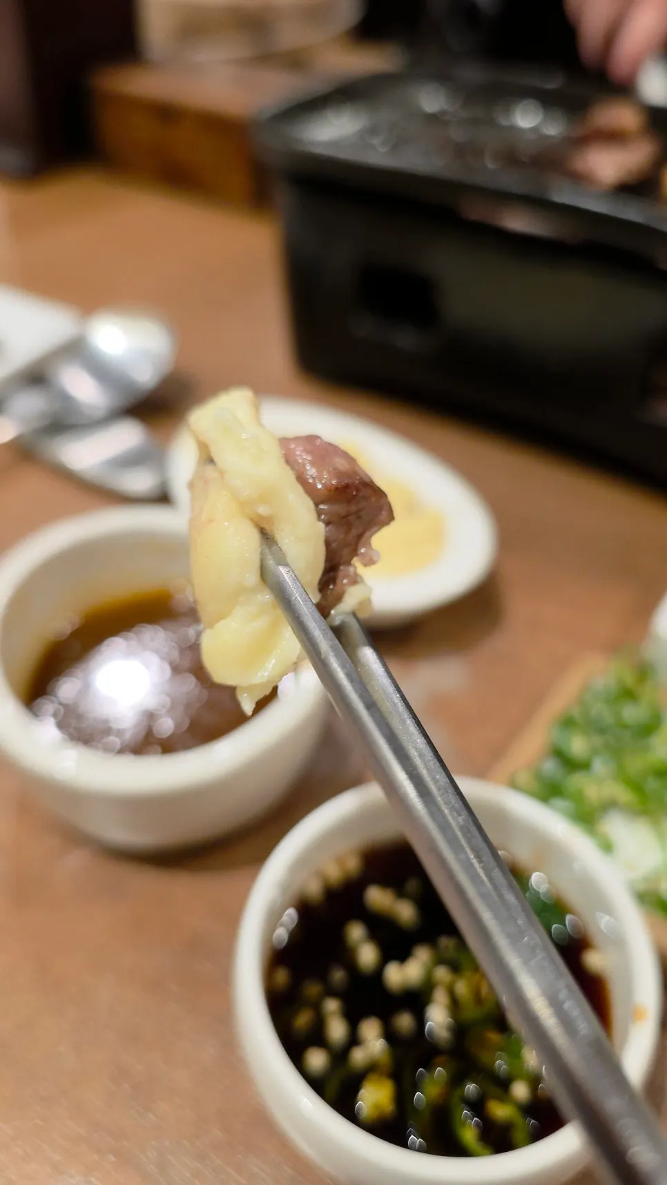A piece of meat dipped into the potato salad