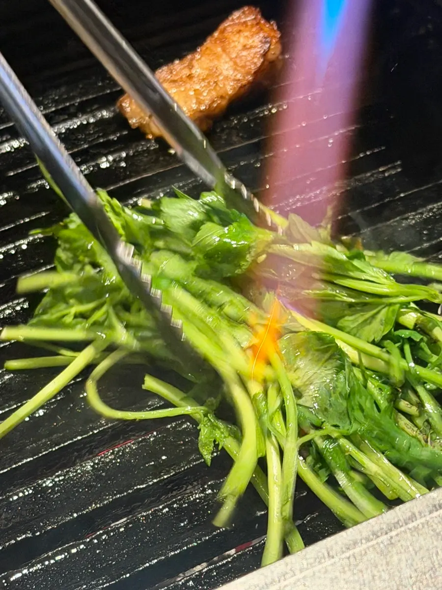 Minari and other vegetables grilling alongside the meat