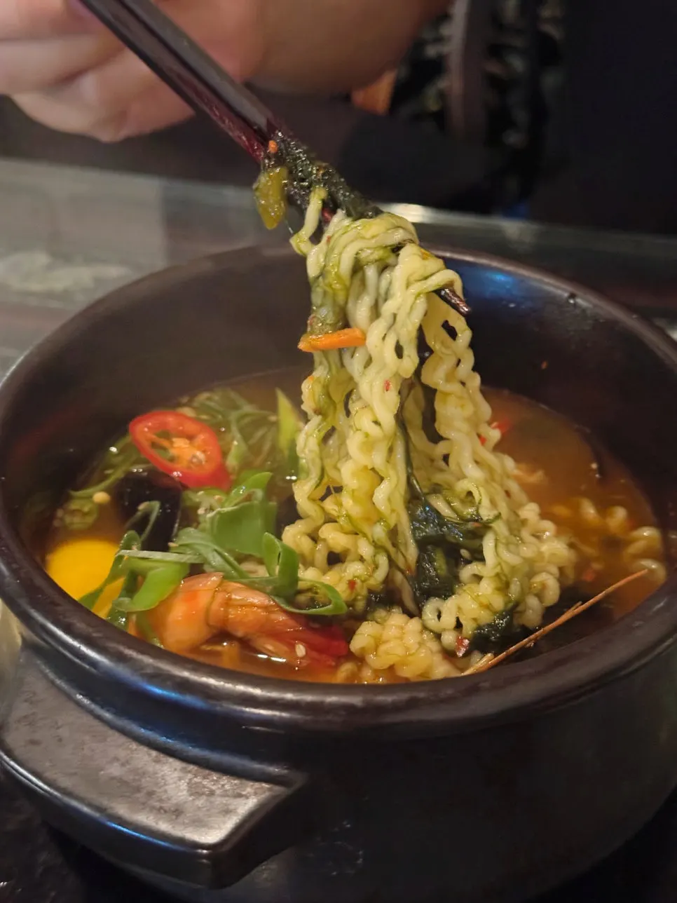 Scooping up noodles from the maesaengi seafood ramyeon