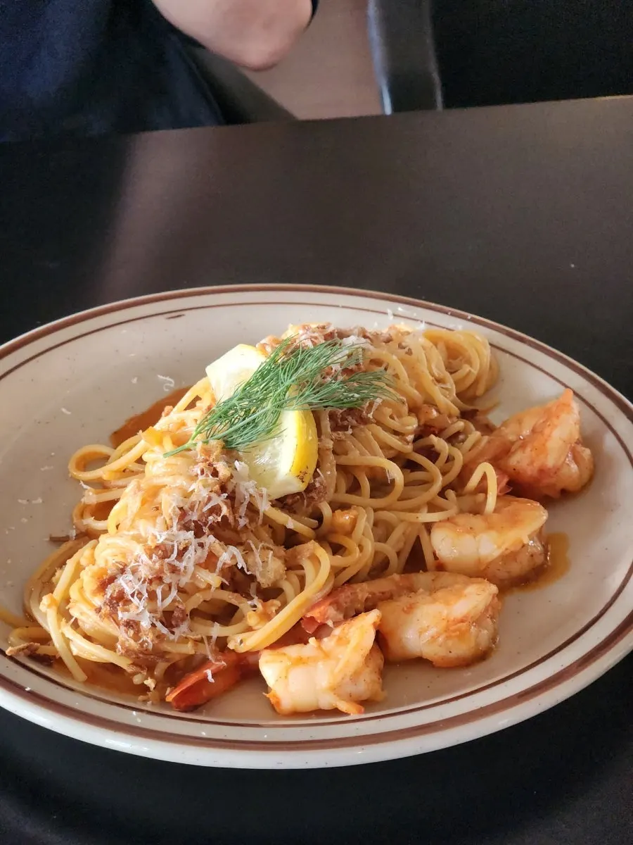 Bisque rosé pasta topped with shrimp