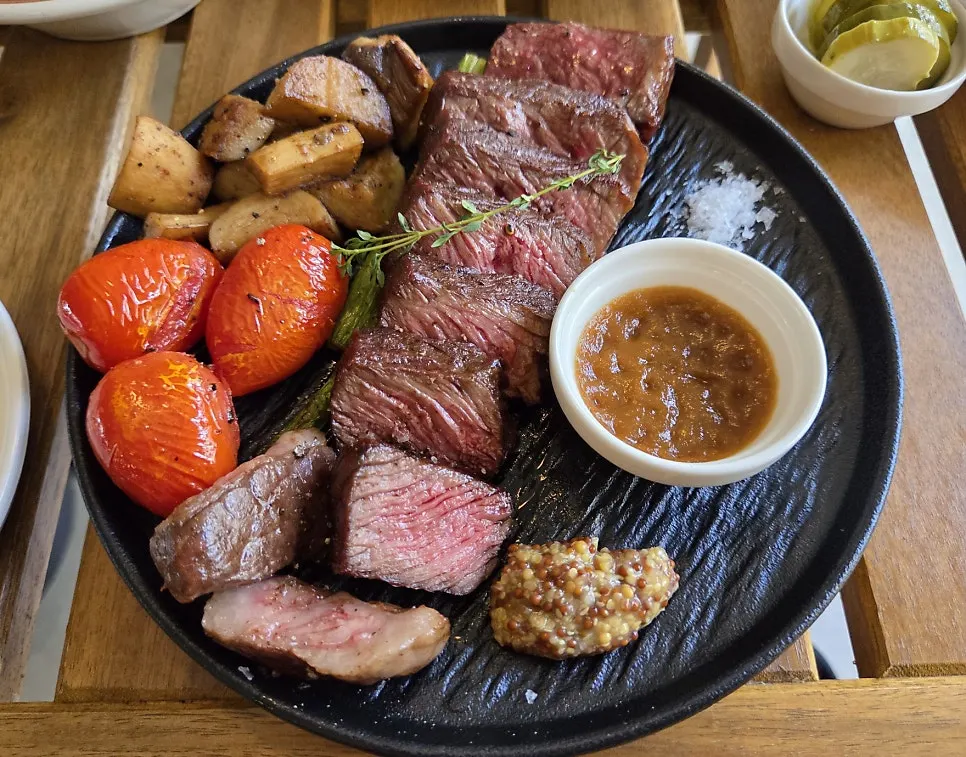 Chuck flap steak platter plated with garnishes