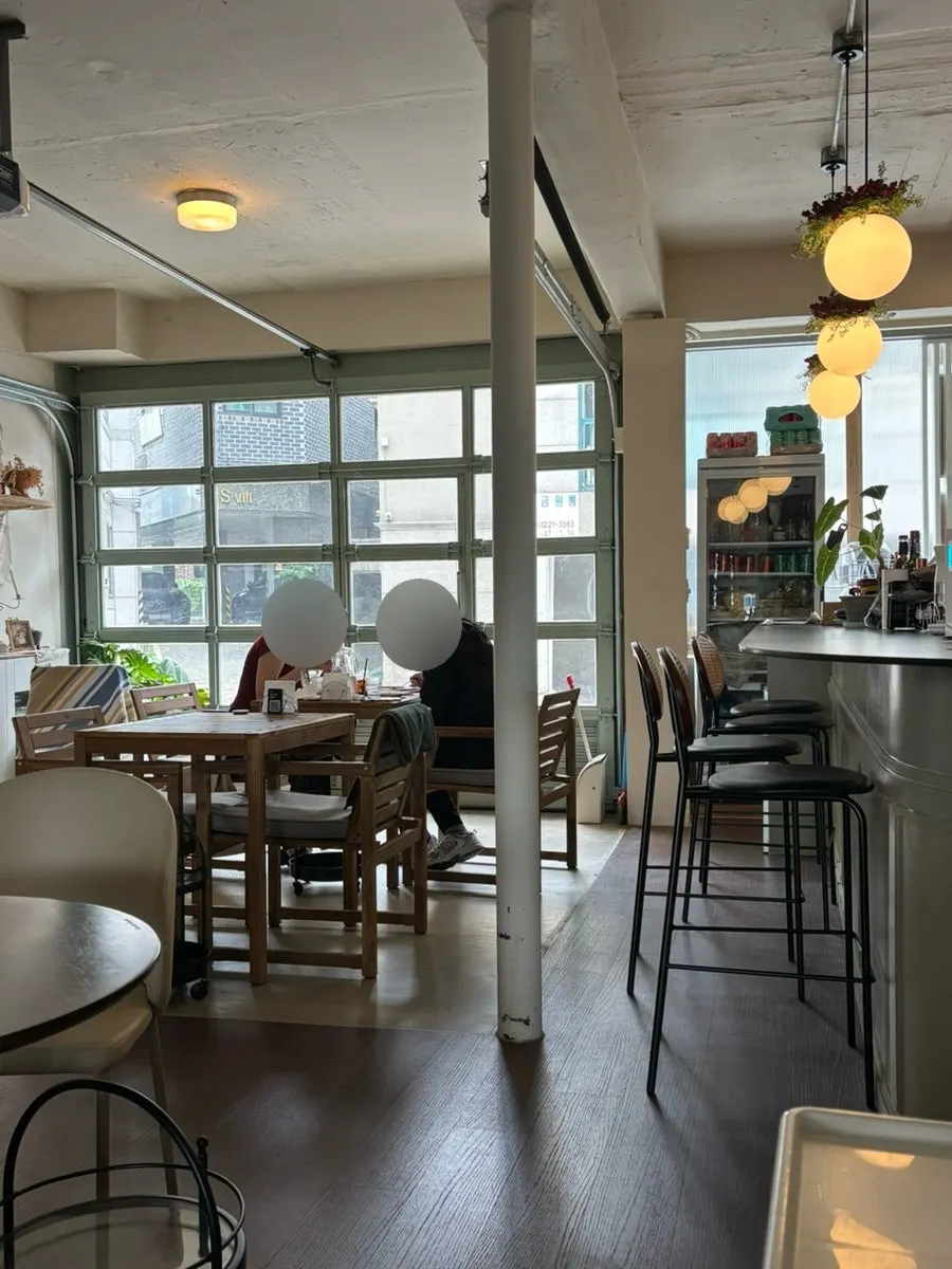 Table by the large windows at Nonchalant Lounge