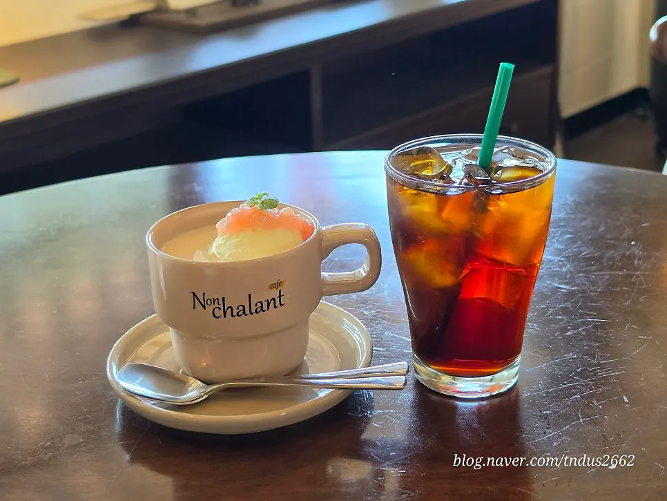 Iced apricot milk tea topped with apricot jam and basil