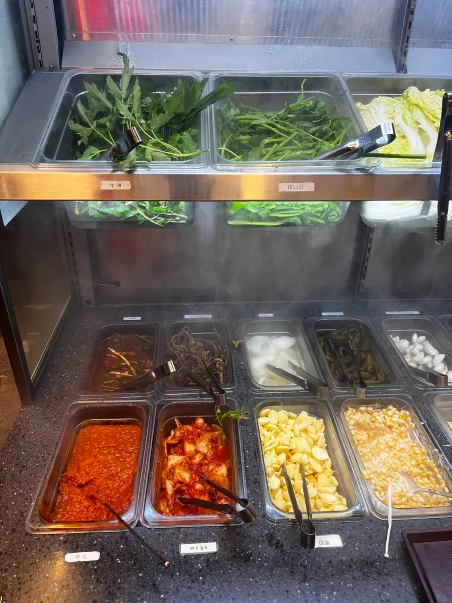Sauces and side dishes displayed at the self-serve bar