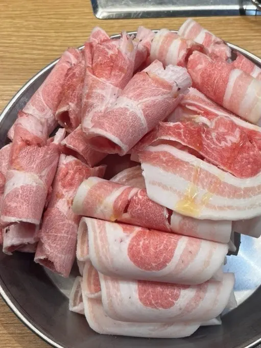 Plate of thin-sliced flower pork belly served