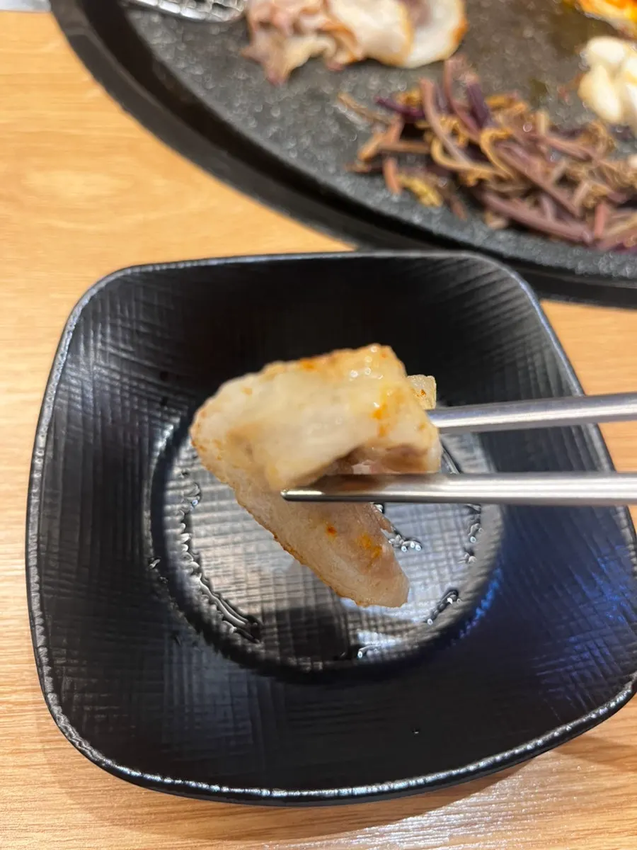 Thin-sliced flower pork belly grilling on the pan