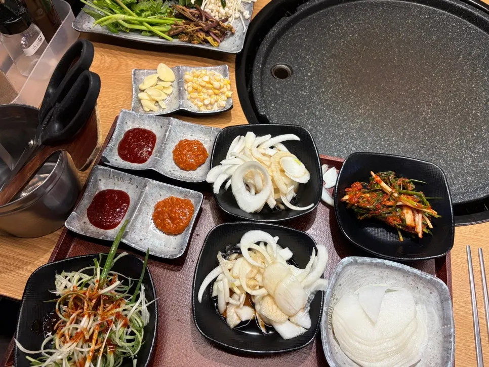 Self-served table setting with green onion kimchi and radish wraps