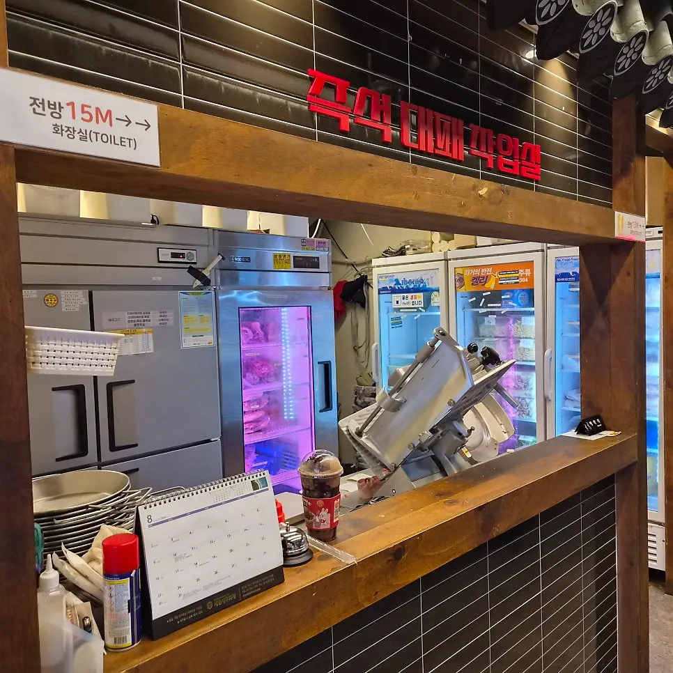 Glass-fronted meat-slicing station inside the restaurant