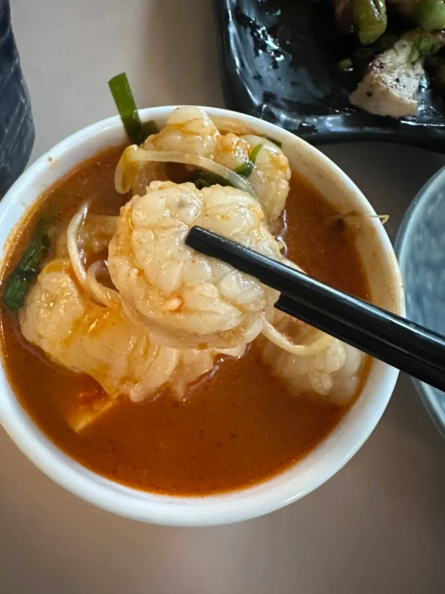 Spicy motsunabe simmering at the table