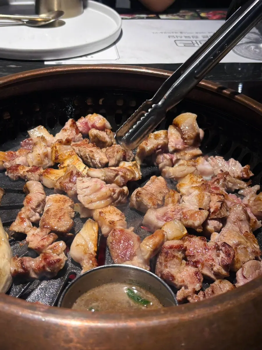 Black pork grilling over charcoal