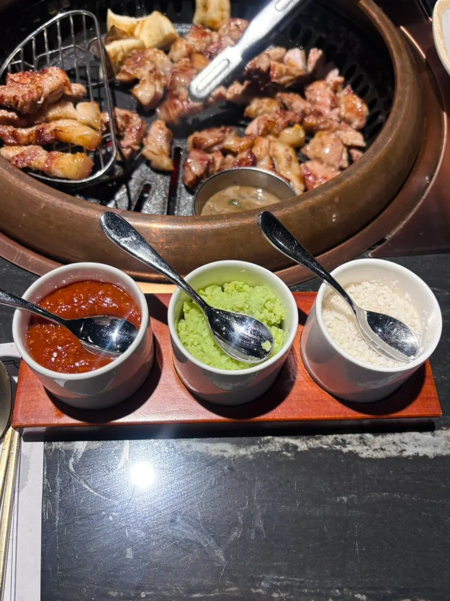 Fully cooked black pork piled up on the side of the grill
