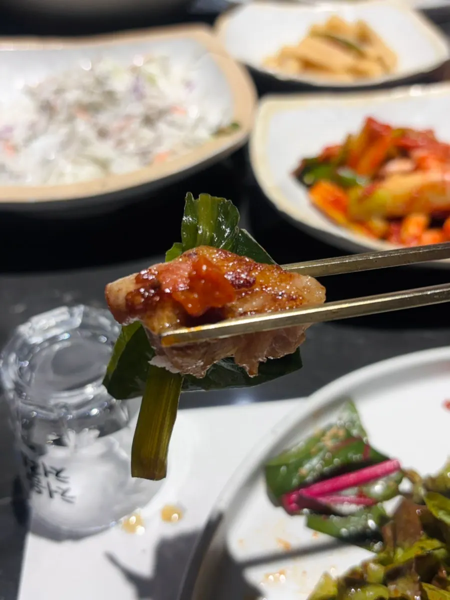 Meat and sauces portioned onto a small plate