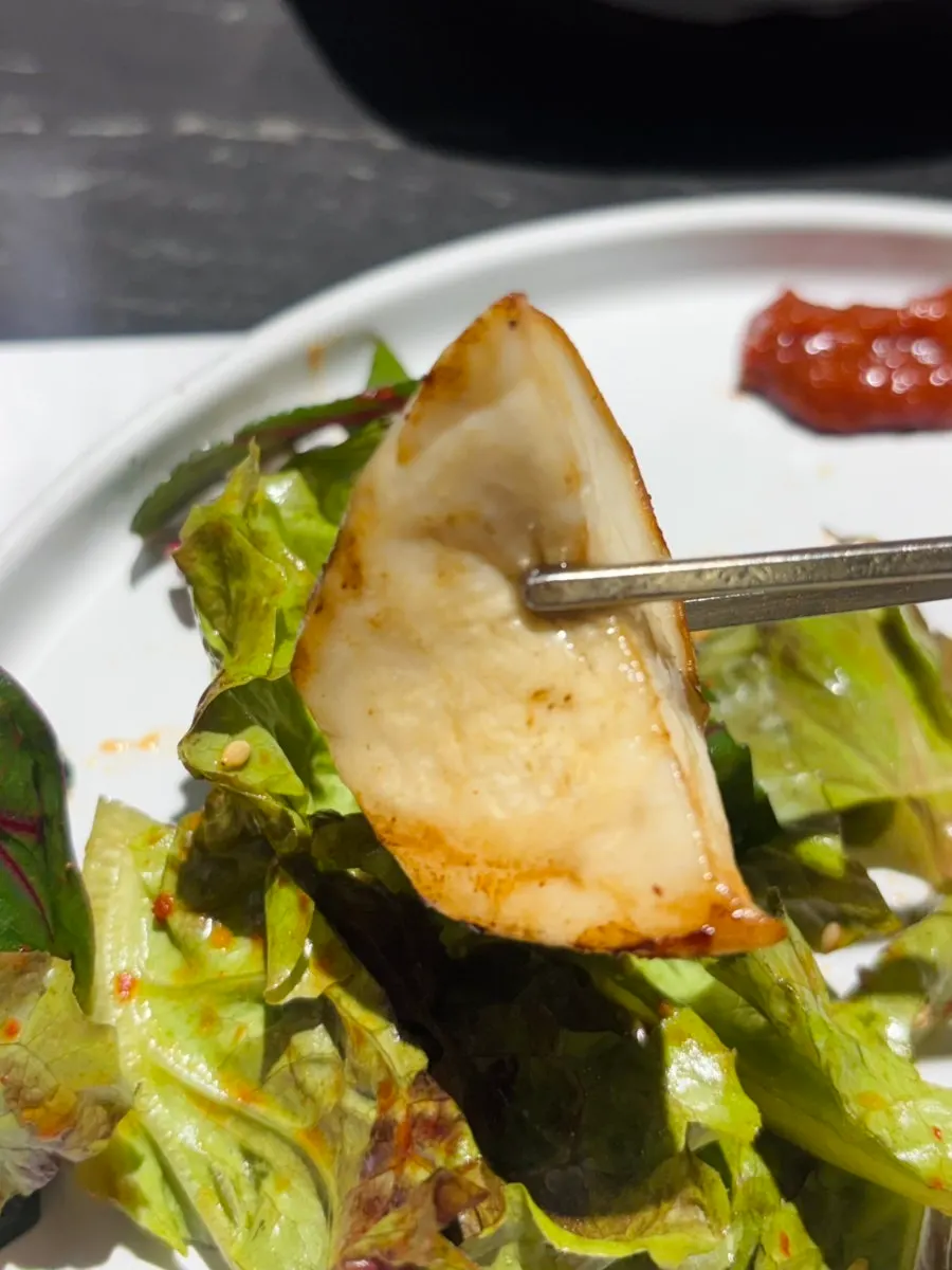 Meat wrapped in lettuce salad and mountain garlic leaves