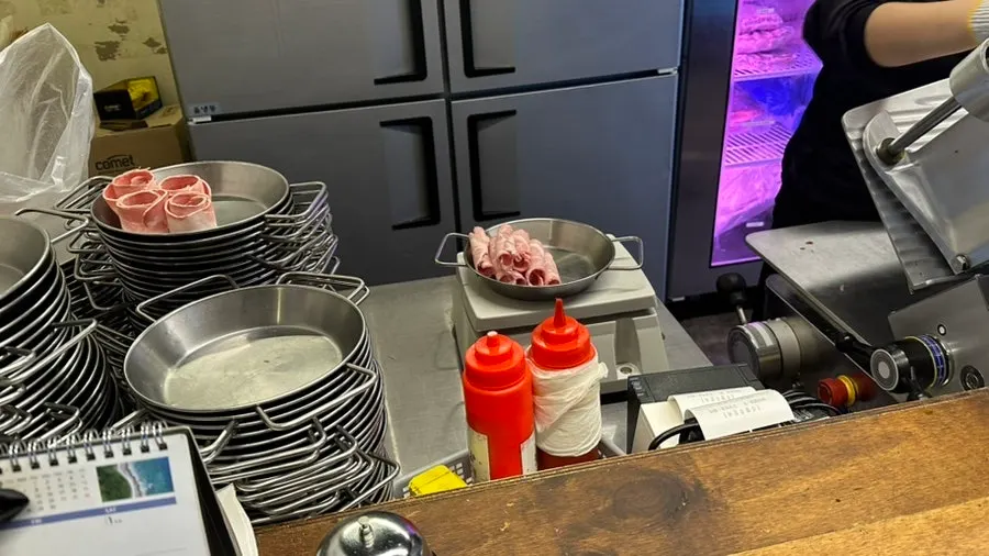 Grill with a tray for cooked meat