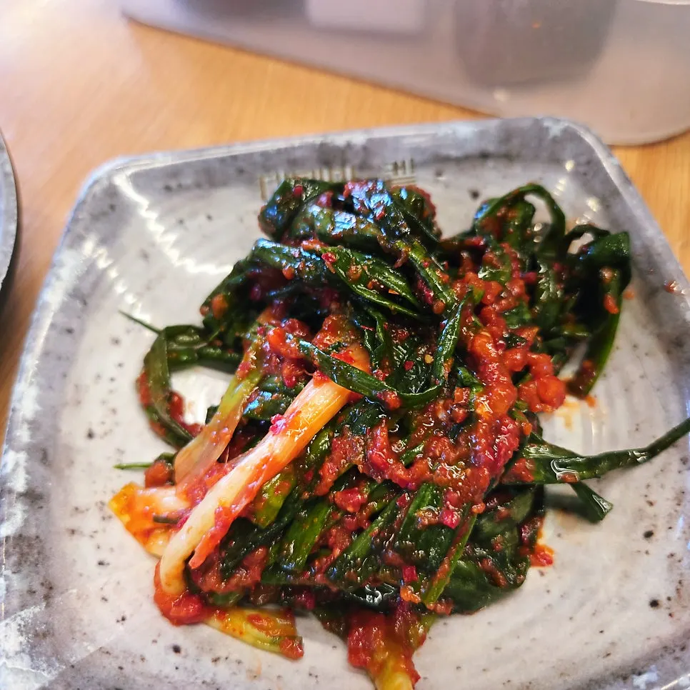 Green onion kimchi and side dishes from the self-serve bar