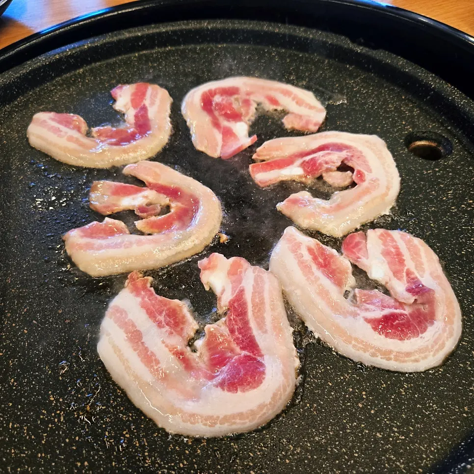 Flower pork belly cooking quickly on the grill
