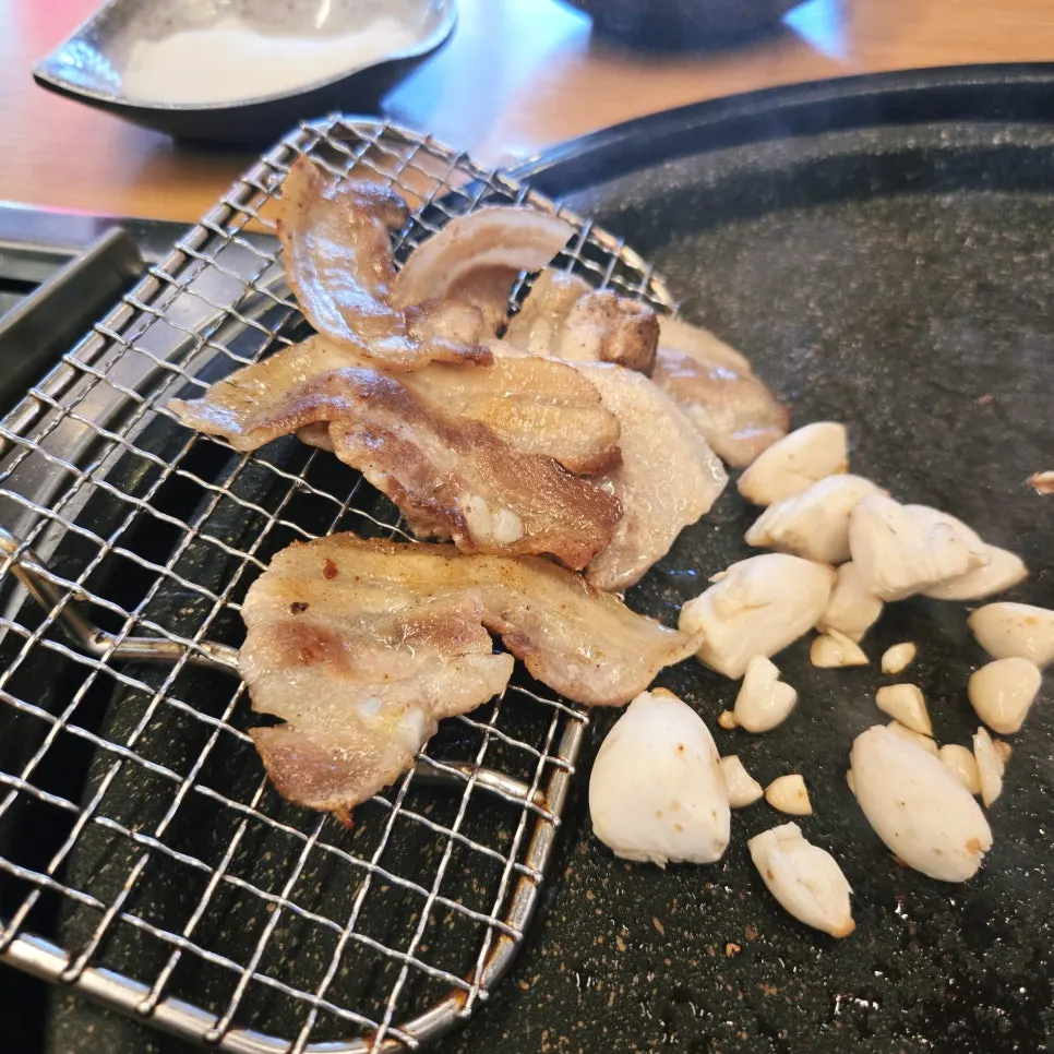 Cooked meat resting on the warming section of the grill