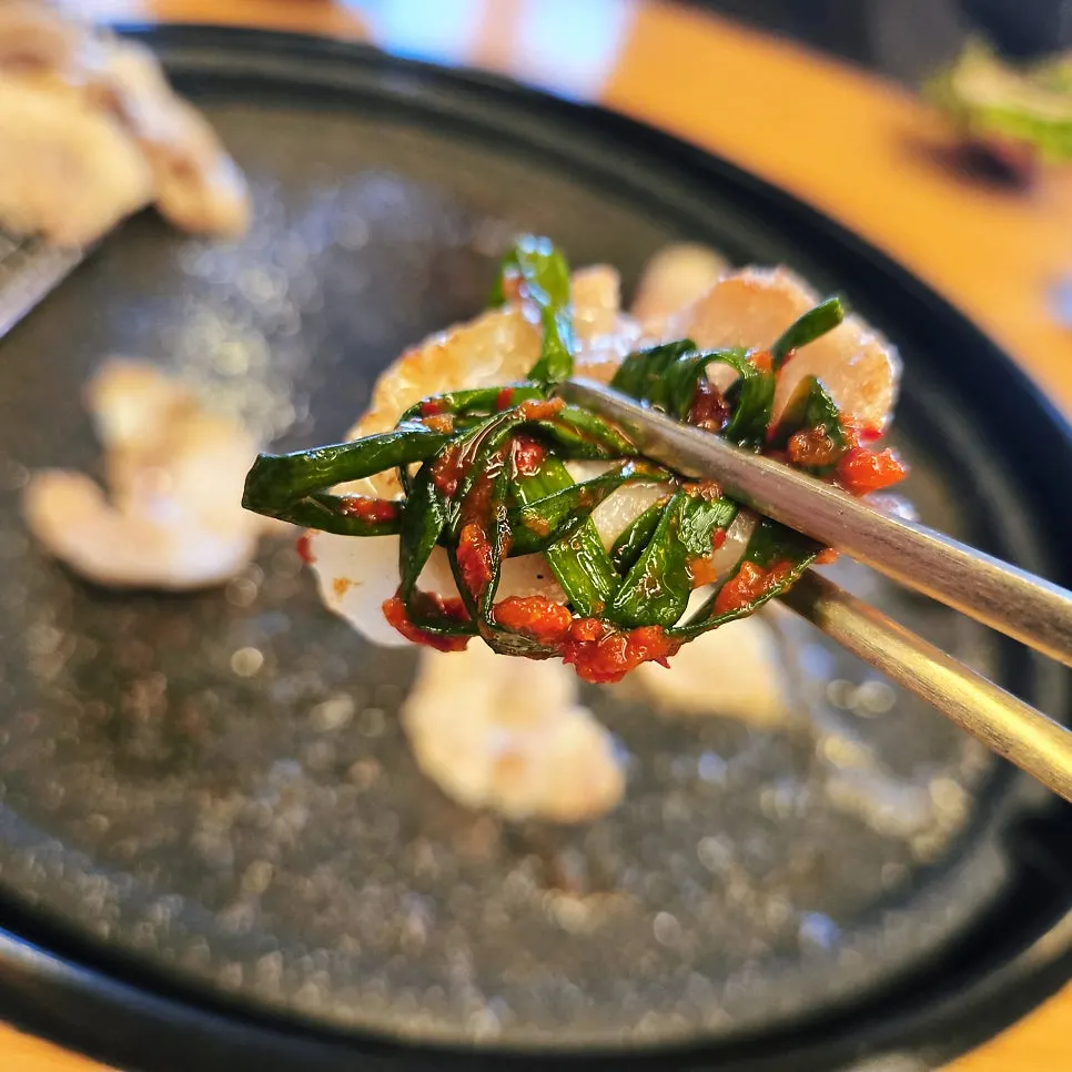 A wrapped bite of meat with side dishes