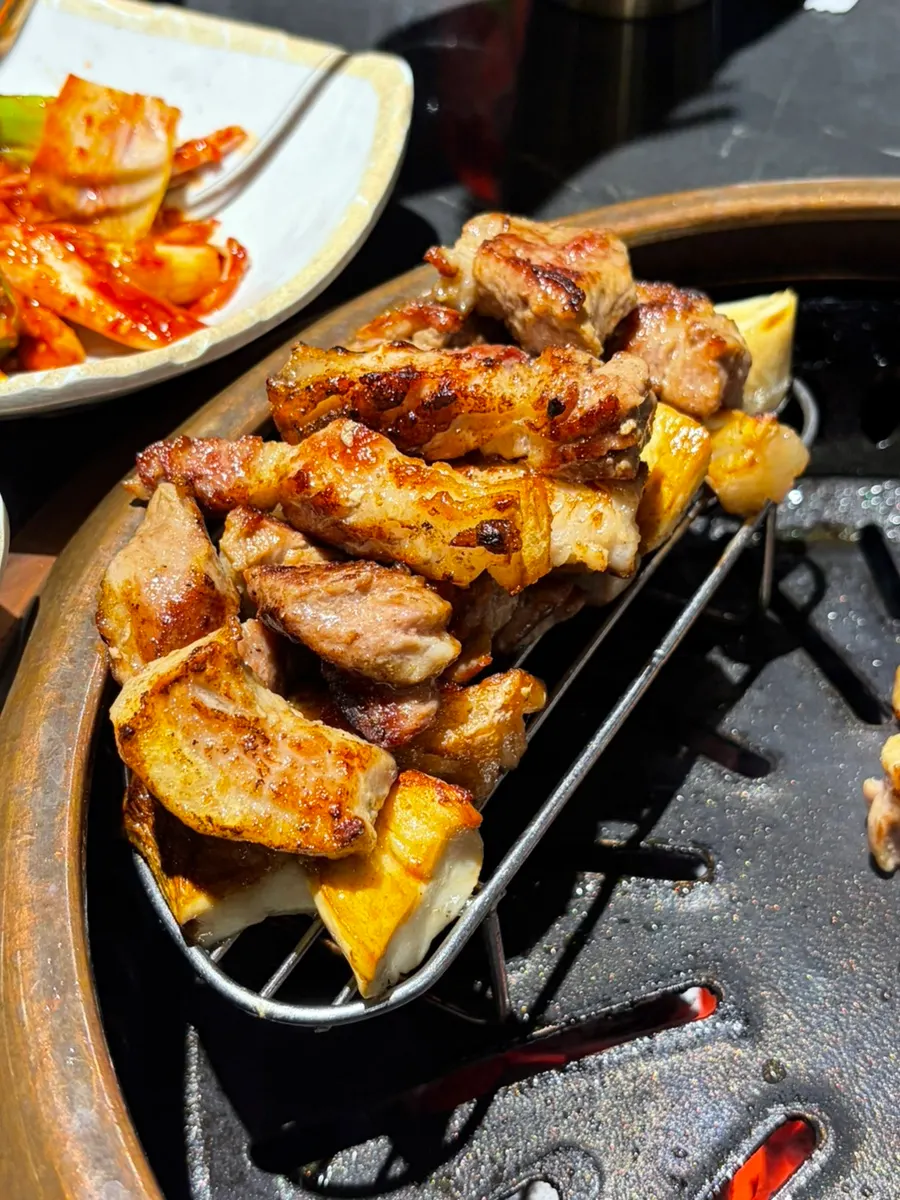 Golden-grilled black pork glistening with juices