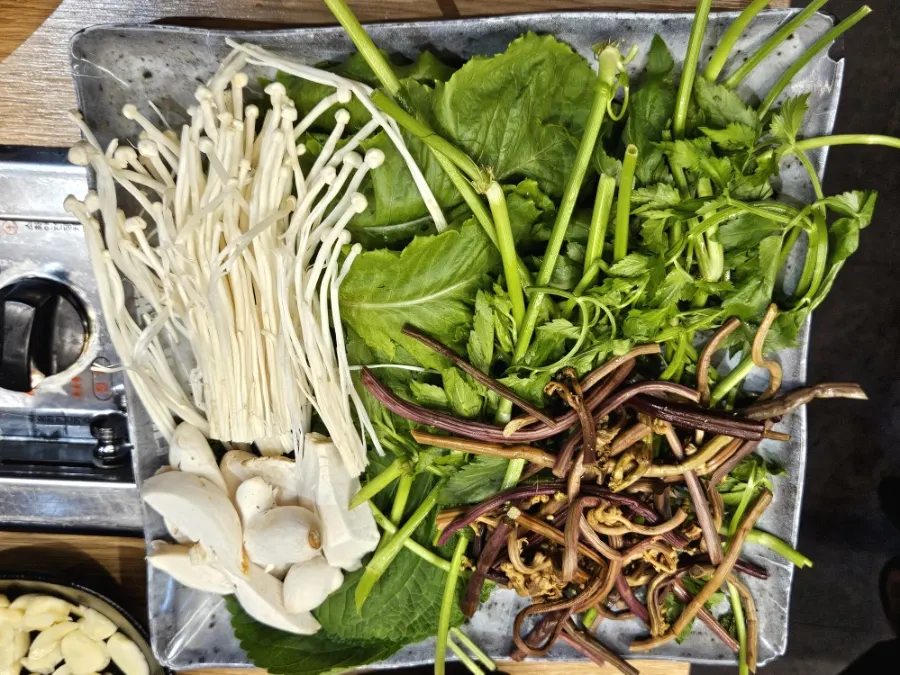 Grill and side dishes set up before cooking the meat