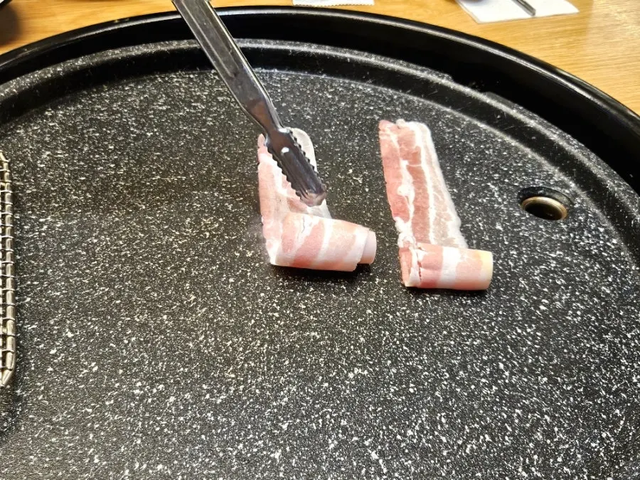 A plate of thinly sliced pork belly