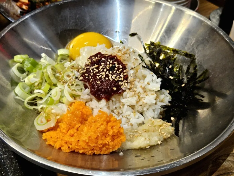 Rice, meat, and kimchi placed on the grill