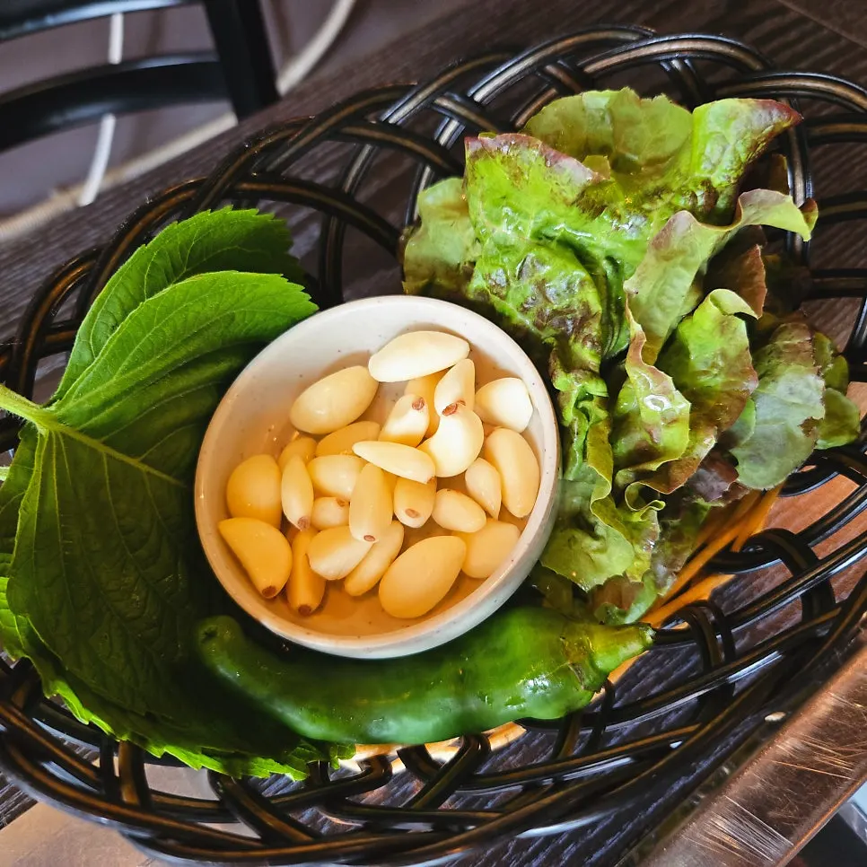 Side dishes including wild garlic leaves and green onion kimchi