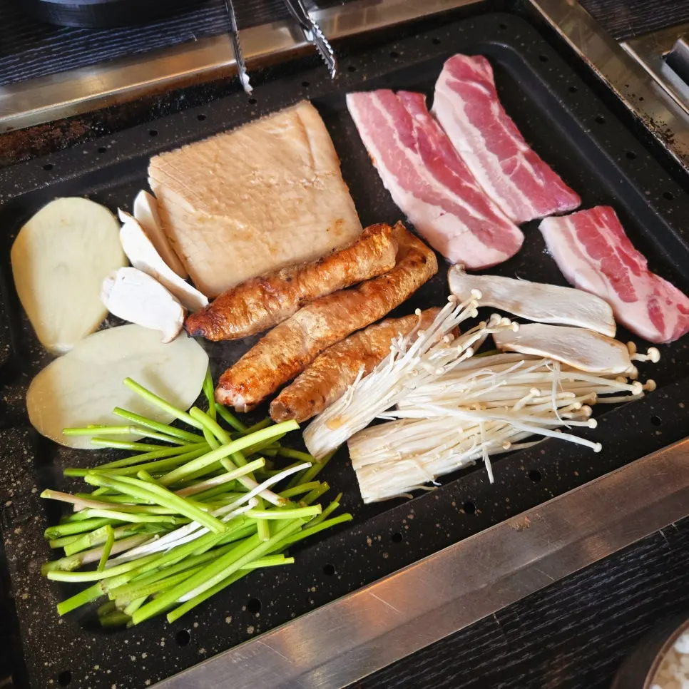 Stone griddle packed full of meat