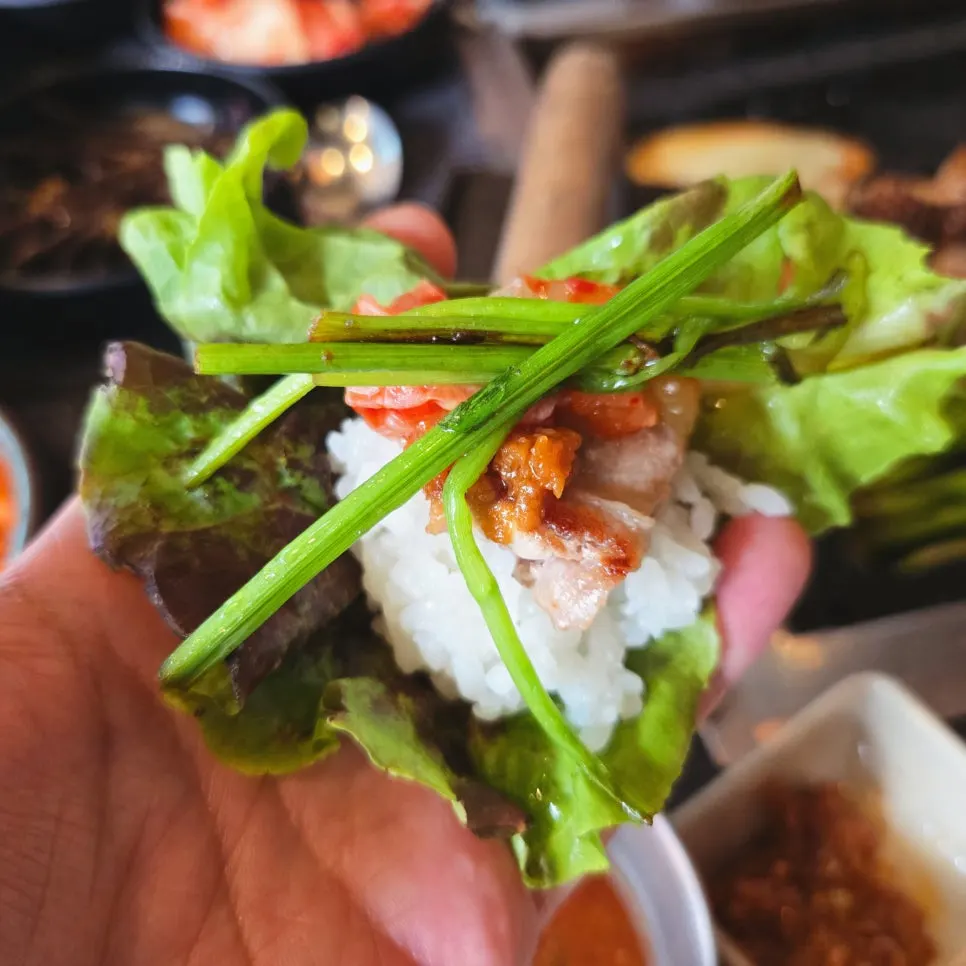 Fully cooked pork belly and makchang on the stone griddle