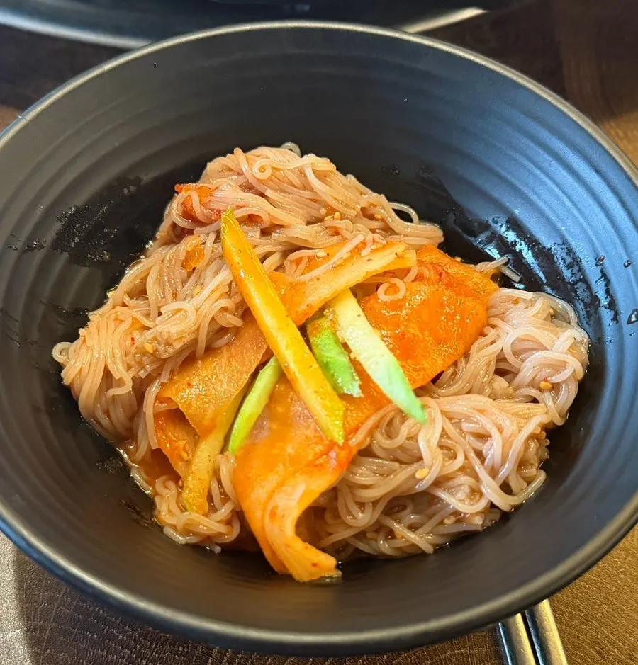 Hamhung-style spicy cold noodles topped with cucumber and boiled egg