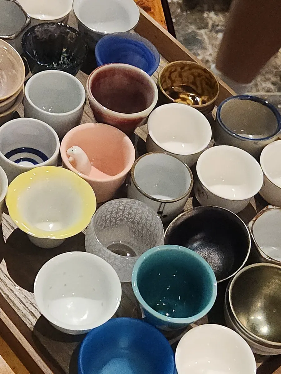 Close-up of various sake cup styles