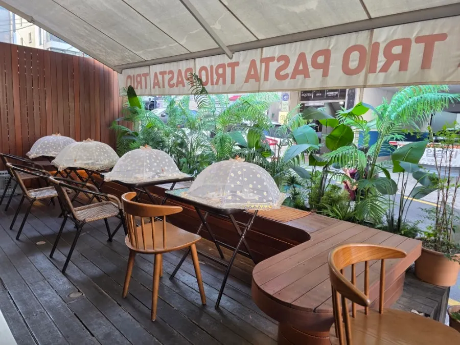 Terrace seating at Pasta Trio with curved chairs