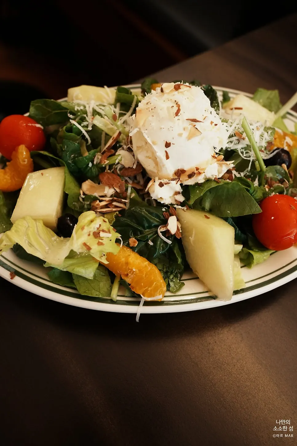 Ricotta salad plate topped with sliced almonds