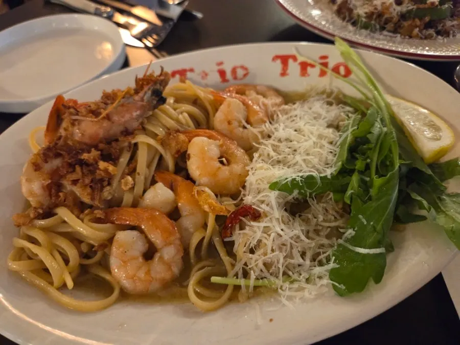 Signature shrimp oil pasta served on the table