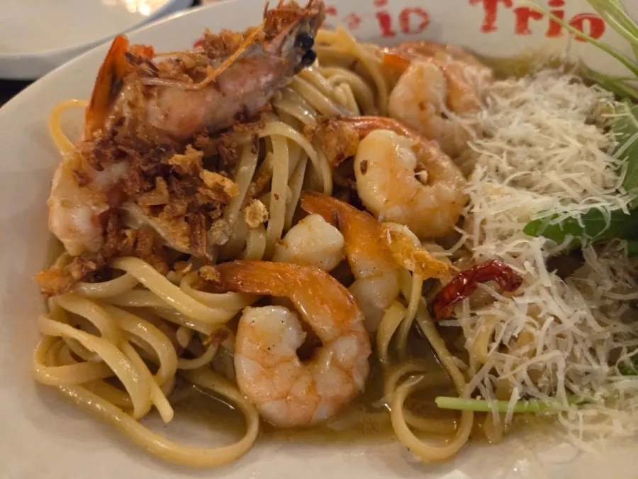 Shrimp oil pasta noodles twirled onto a fork