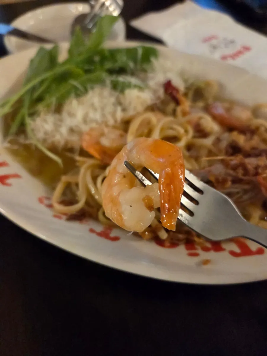 Vertical shot of Pasta Trio's oil pasta