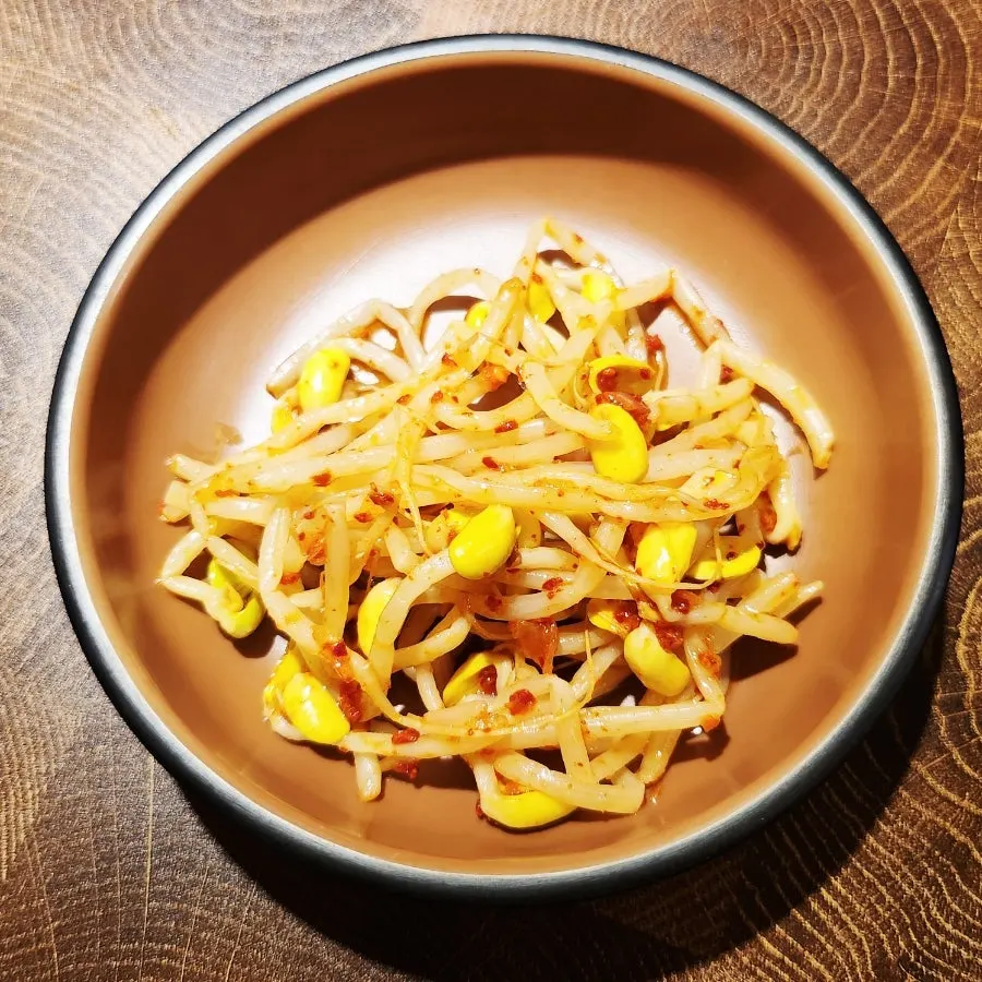 Seasoned bean sprouts served with pork barbecue