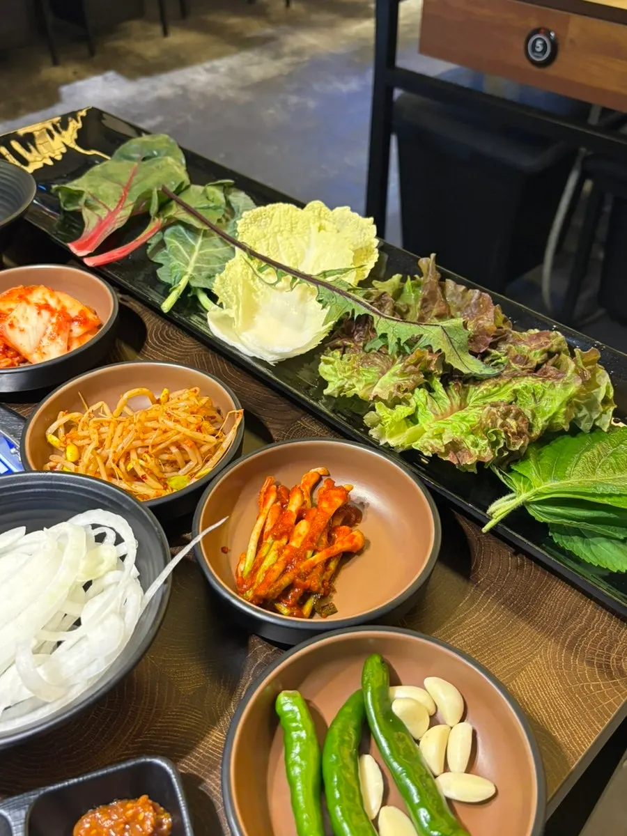Plate of fresh perilla leaves and lettuce for wraps