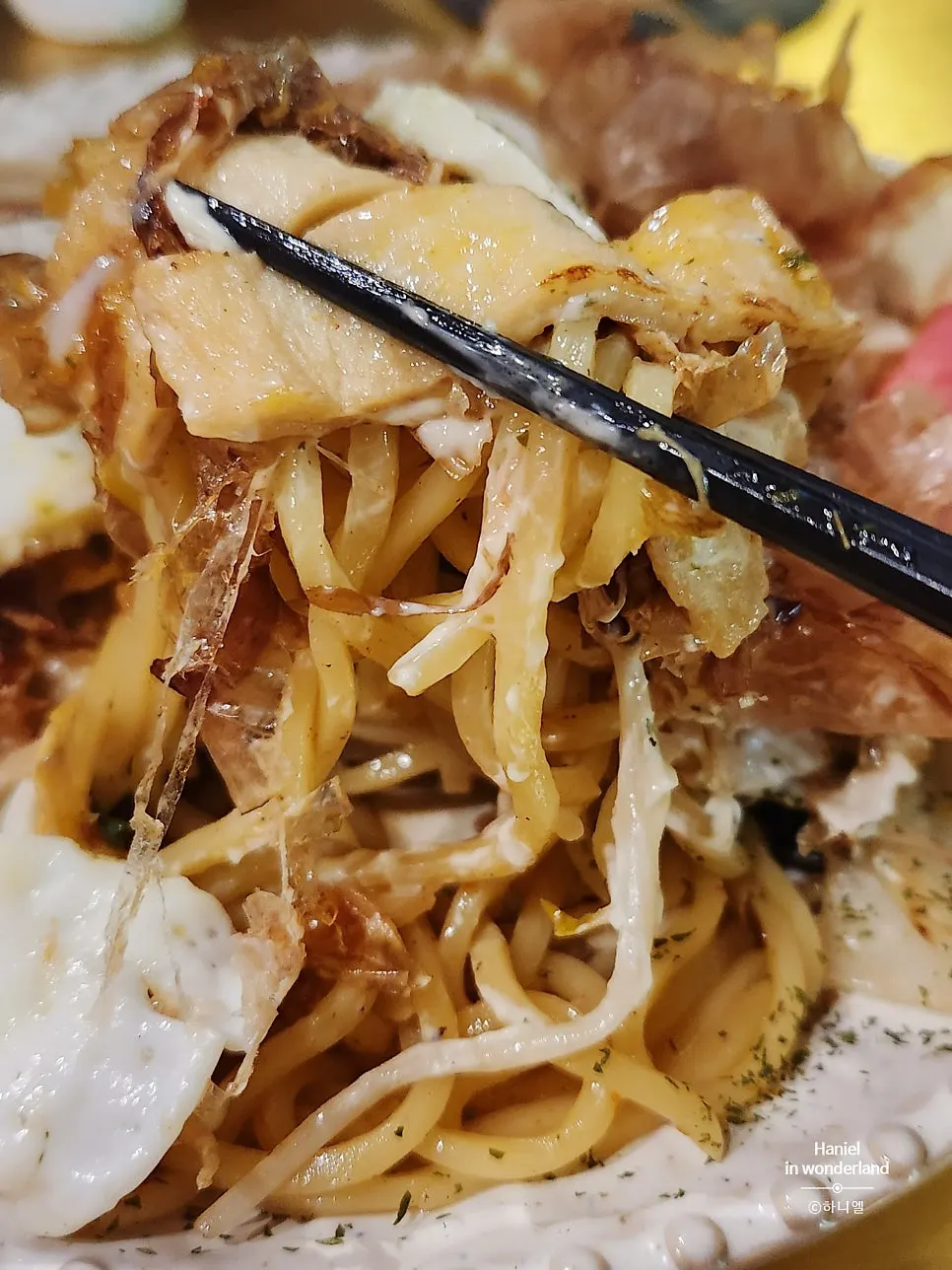 Whiskered yakisoba topped with a fried egg