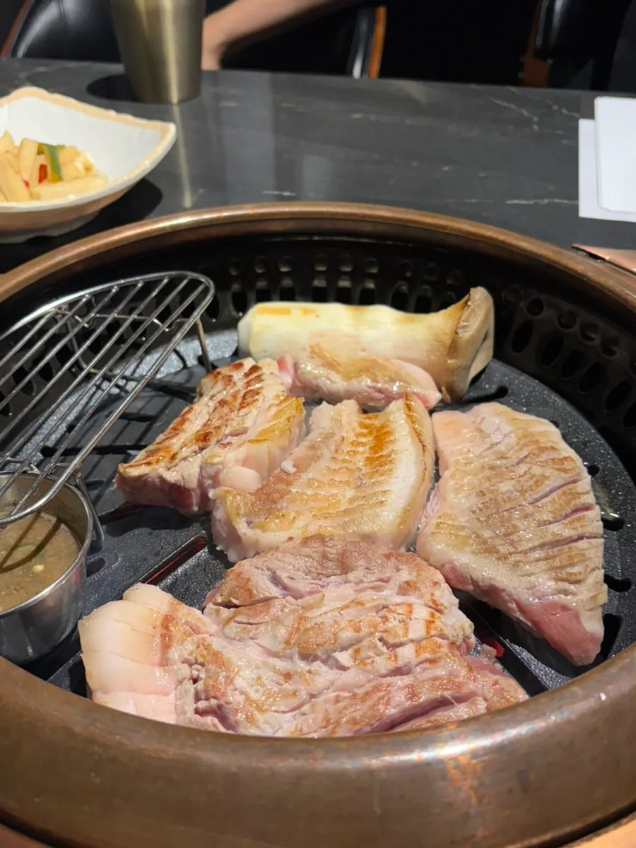 Staff member grilling the meat on the grill