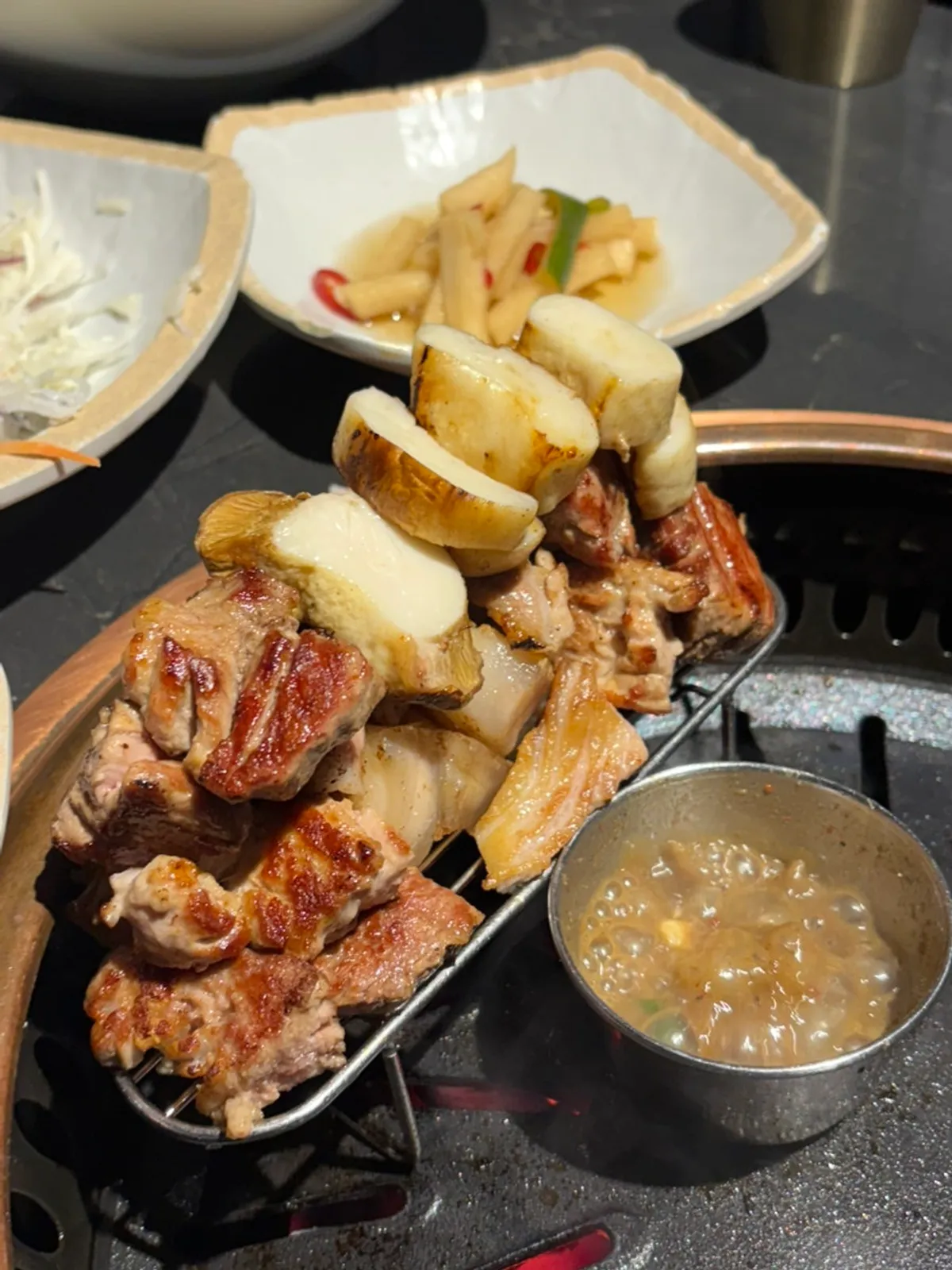 Mushrooms and Jeju black pork sliced and placed on the grill
