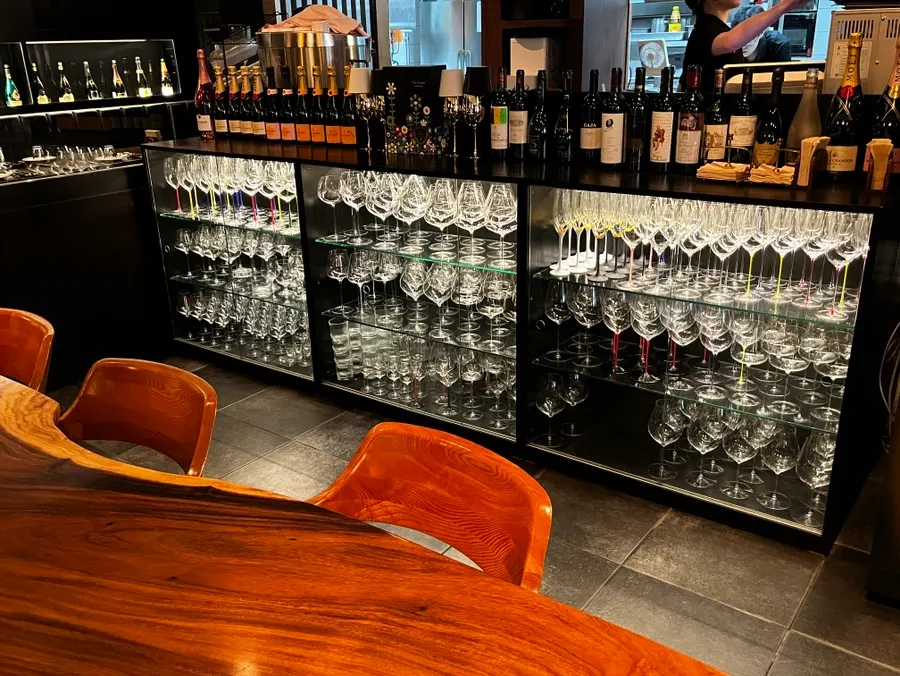 Large wine cellar and wine glasses at Luna Vine's entrance