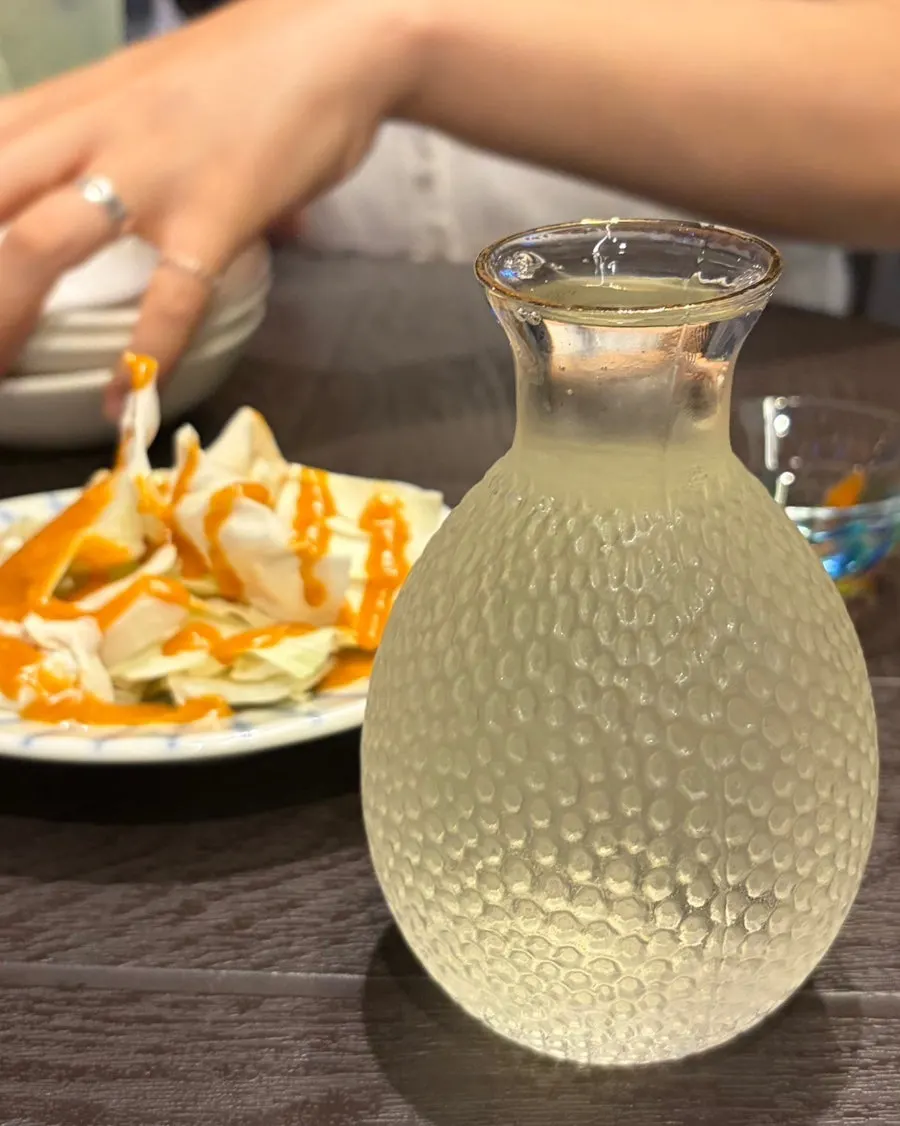 Green tangerine sawa and house sake served in hand-picked glasses