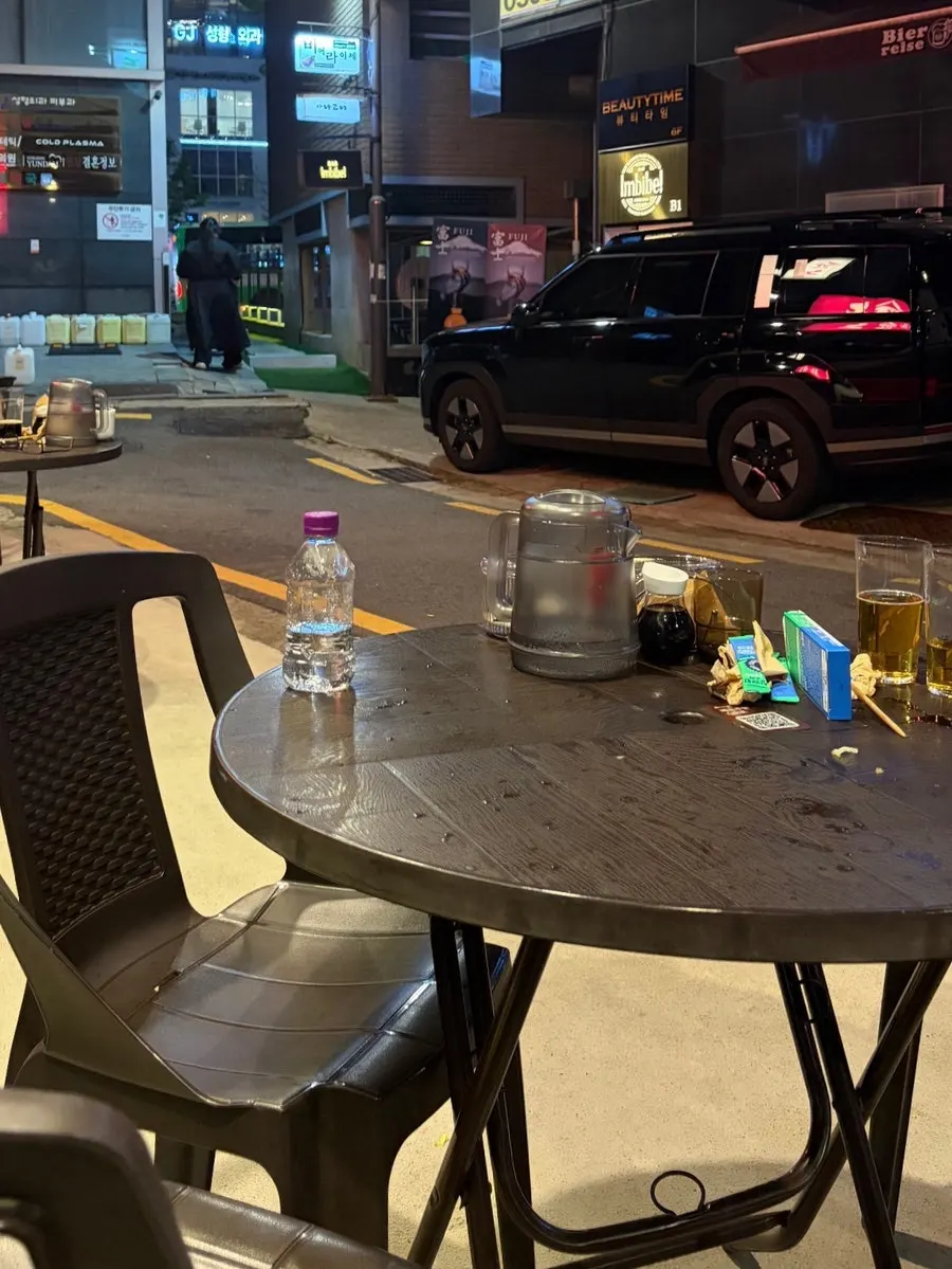 Finishing up with fish cake snacks and a glass of sake outdoors