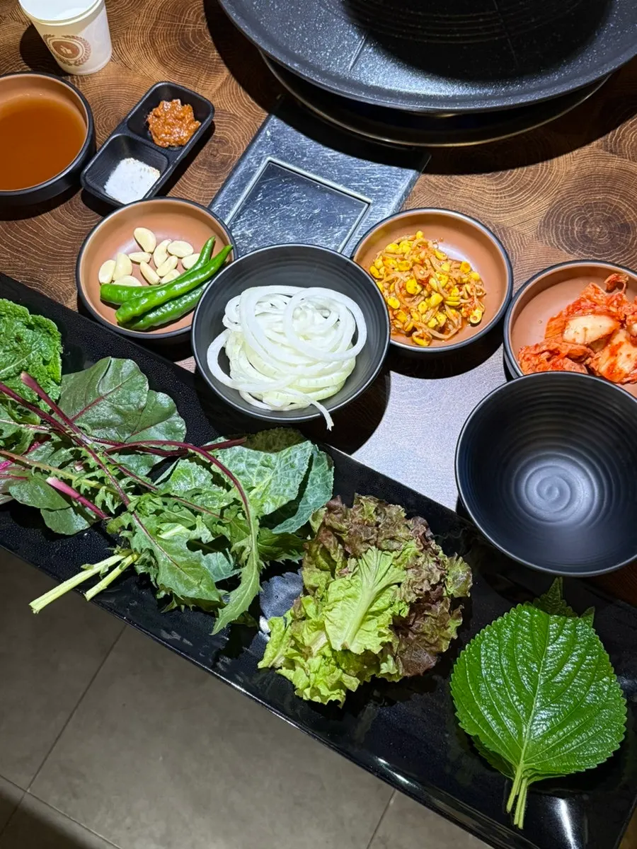 Table set with side dishes like kimchi and scallion kimchi