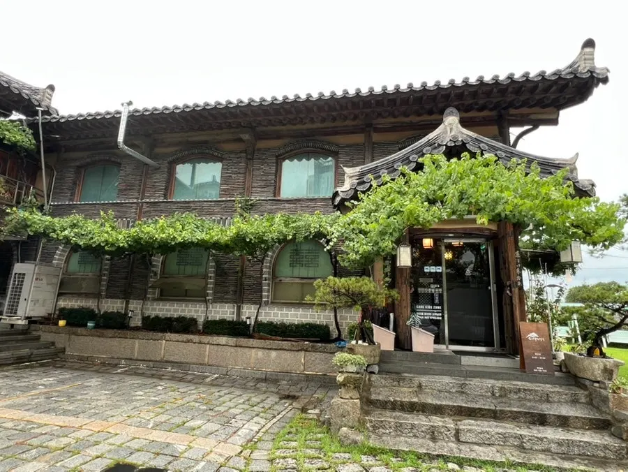 Entrance of the hanjeongsik restaurant lined with pine trees