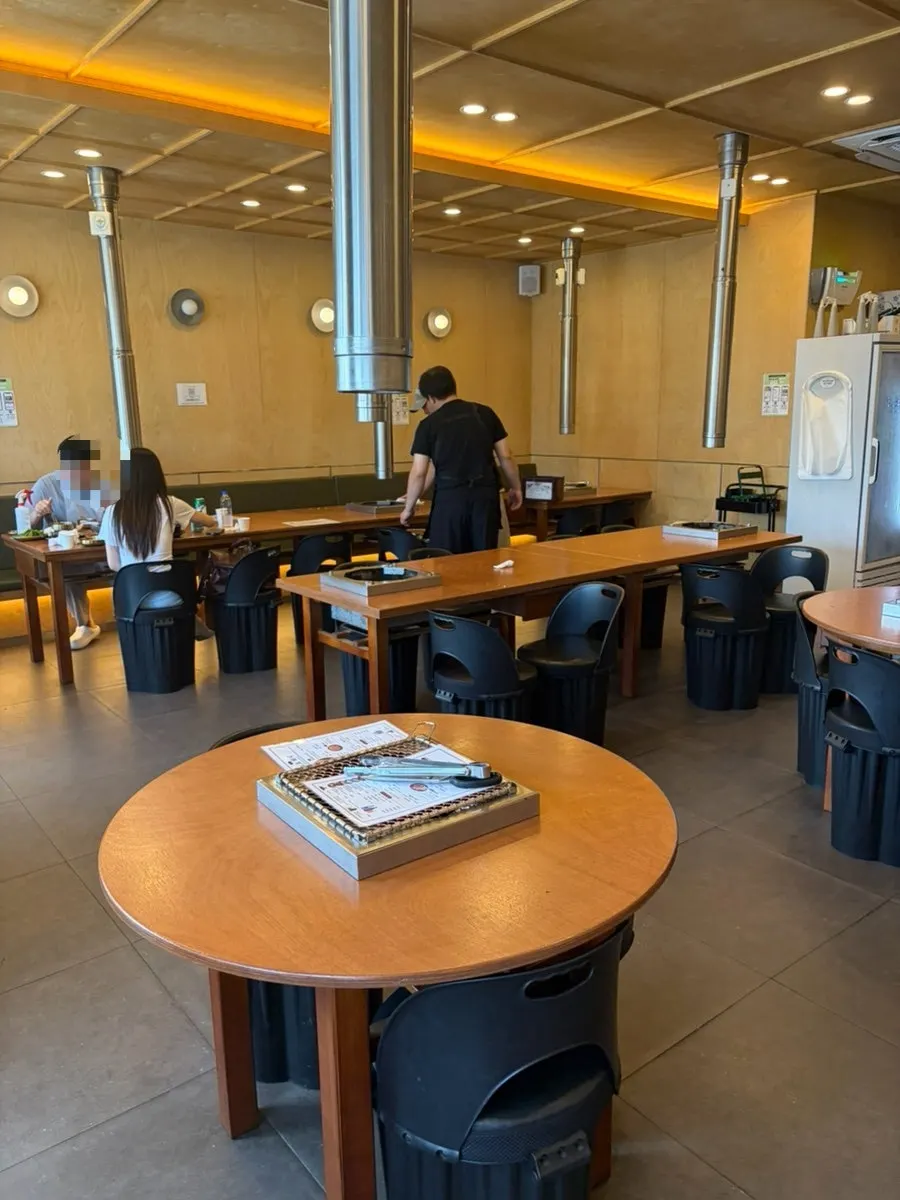 The restaurant's interior in unified wood and black tones